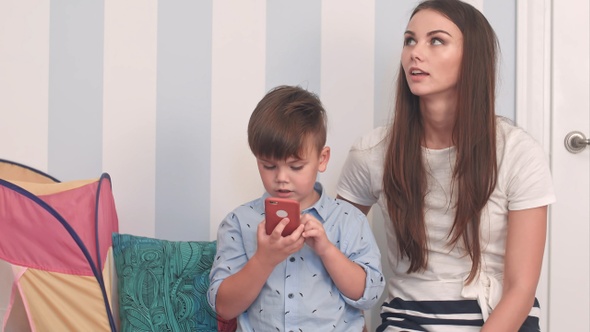 Mother and son playing with mobile phone