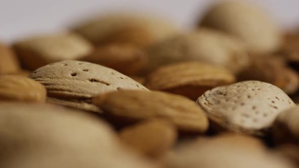 Cinematic, rotating shot of almonds on a white surface - ALMONDS