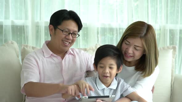 Asian Family Using Tablet At Home