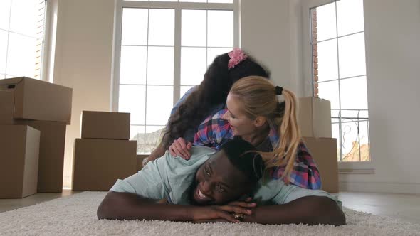 Happy Family Hugging While Making Stack on Carpet