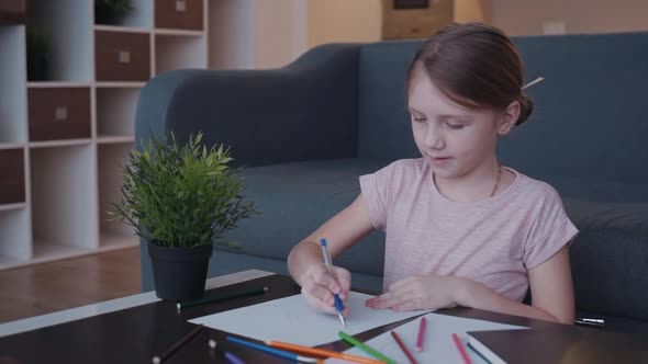 Preteen Girl Drawing Picture on Paper and Using Pencil