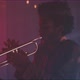 Trumpeter playing in a room with smoke and red neon lights - VideoHive Item for Sale