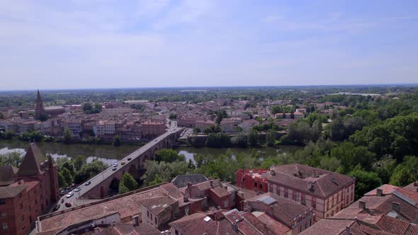 Saint James cathedral, Old Bridge and Ingres Museum approaching in Montauban France, Aerial flyover