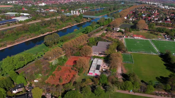 Top view of the embankment of the Neckar River. Bridges, green grass and trees. Mannheim. Germany.
