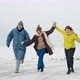 Full length view of the caucasian friends enjoying of the winter holidays while running - VideoHive Item for Sale