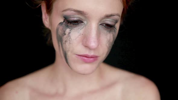 Young Woman Crying on Black Background