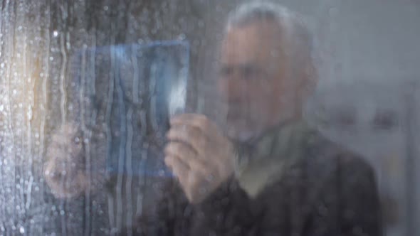Pensive Old Man Looking X-Ray Image, Thinking Bad Diagnosis, Illness Depression