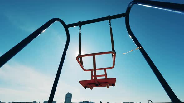 Swaying Swings in the Open Air with No One Using Them