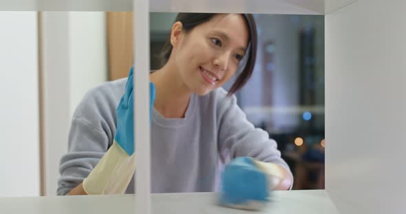 Woman Clean the Cabinet at Home