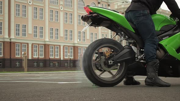 Biker on a Motorcycle Drifts in Smoke