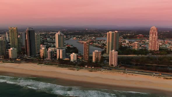 Sunrise ,Surfers Paradise,pink sky at dawn.Panning right Beach and Surf