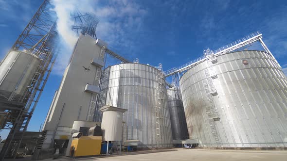 Grain elevators outdoors. Aluminum containers for storing grain. Agribusiness.