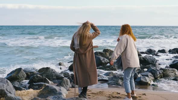 Beautiful Girls Walk Near the Sea