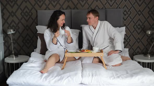 Romantic Caucasian Couple Having Breakfast in Bed