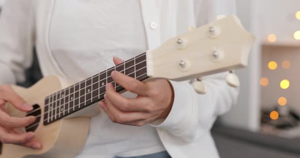 Woman playing ukulele