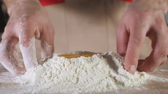 Baker is Making a Dough on the Table