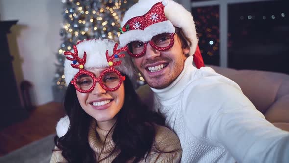 Happy couple celebrating christmas at home.