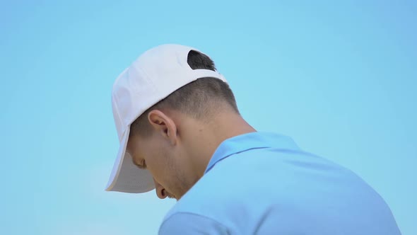 Young Man Playing Golf and Feeling Sudden Sharp Pain in Neck During Hit, Sprain