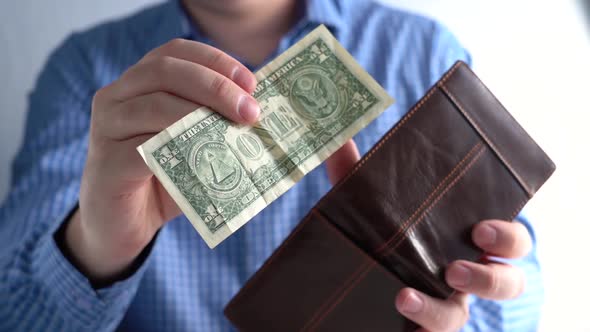 Closeup of One Dollar and Wallet in Hands