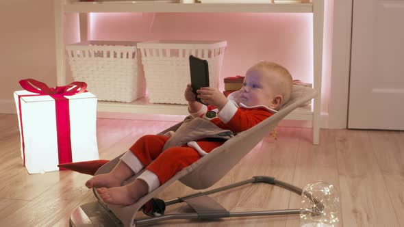 Child Dressed in Santa Claus Having Fun on New Years Eve Using Smartphone Happy Kid Celebrates His