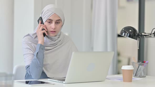 Attractive Young Arab Woman Using Smartphone in Office