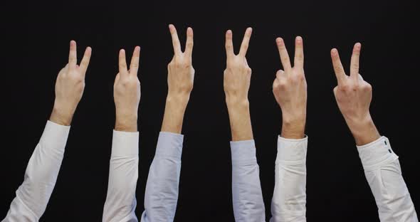 Men's hands raising victory sign