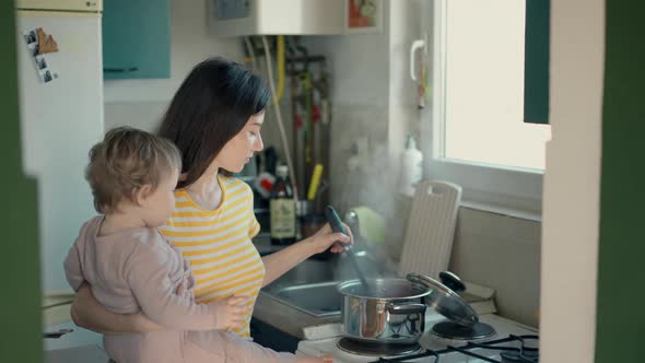 Cinematic Authentic Shot of Happy Mother and Her Little Toddler Baby Boy Son are Having Fun to Make