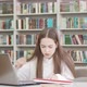 Teen Female Student Stressing Out While Working on a Project at the Library - VideoHive Item for Sale