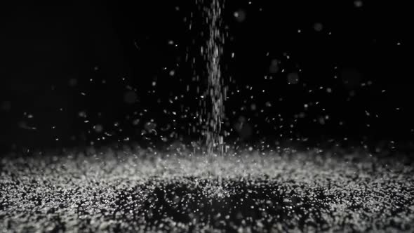 Particles of White Dry Sand Pour in Stream Hit the Surface and Scatter in Different Directions on an