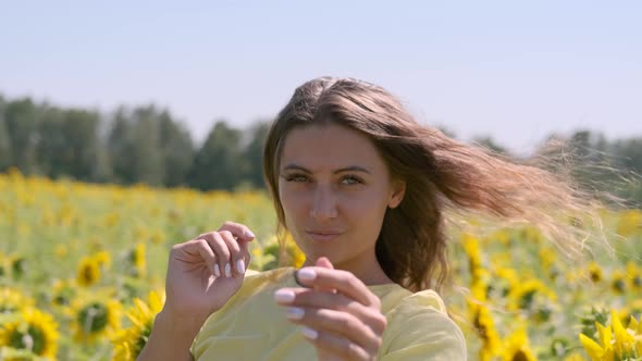 Beautiful Woman Posing While Standing in a Field with Sunflowers