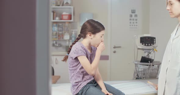 Female doctor examining a sick young girl in the clinic