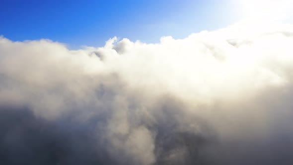 Aerial view up from the clouds to the sky in motion. 