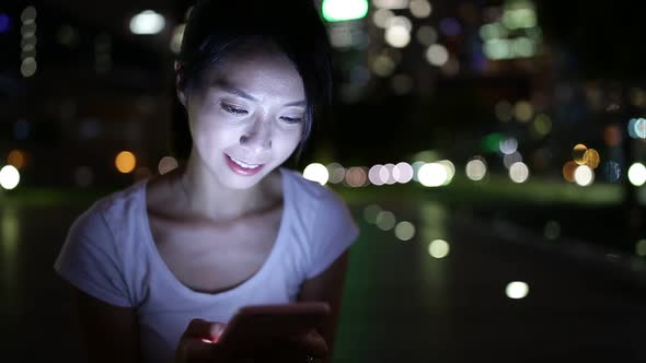 Woman use cellphone at night