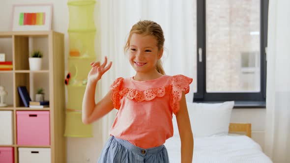 Happy Little Girl Dancing in Her Room at Home