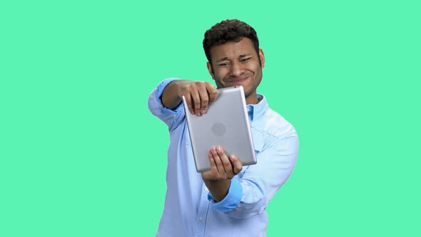 Happy Indian Man Playing Video Game on Tablet Pc