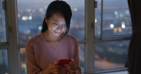 Woman look at mobile phone in the evening