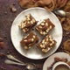Top View of 4 Square Dark Peanut Brownies with Nuts on a Ceramic Saucer - VideoHive Item for Sale