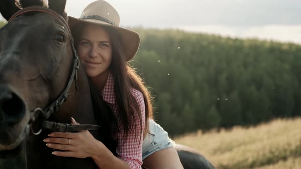 Beautiful Girl Riding a Horse in Countryside. Female Rider Rides a Graceful Horse. Horseback Riding