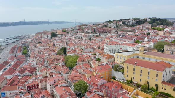 Flying Over Rooftops of Colorful Houses in Dense Urban City Center of Lisbon Portugal