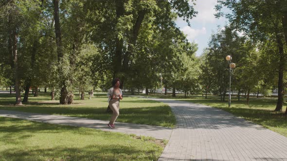 African American Woman Jogging Outdoors in Summer