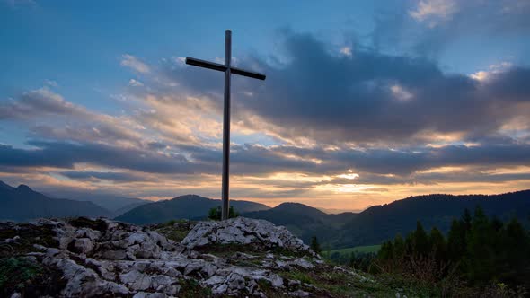 Christian Cross On A Rock At Sunset