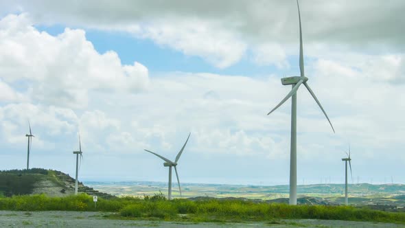 Windmill Propellers Spinning. Green Energy Generation. Clouds in Stormy Sky