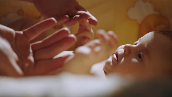 Closeup Shot of Baby's Little Hand Reaching for Father's Loving Finger