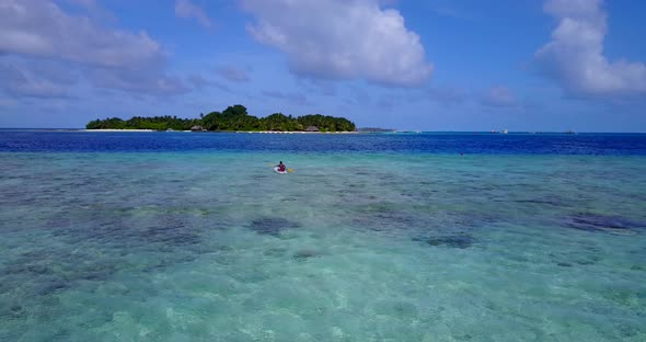 Natural drone clean view of a paradise sunny white sand beach and aqua blue water background in colo