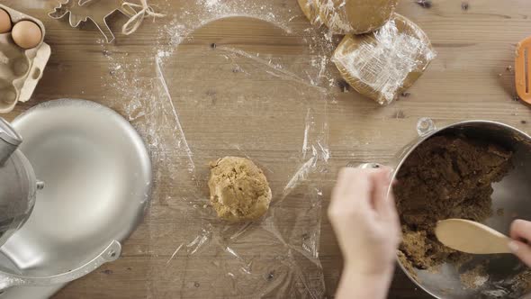 Step by step.  Wrapping gingerbread cookies dough in food cellophane.