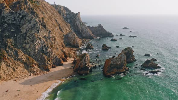 Aerial Drone View of Praia Da Ursa Beach in Sintra Portugal in Sunset Golden Hour Light