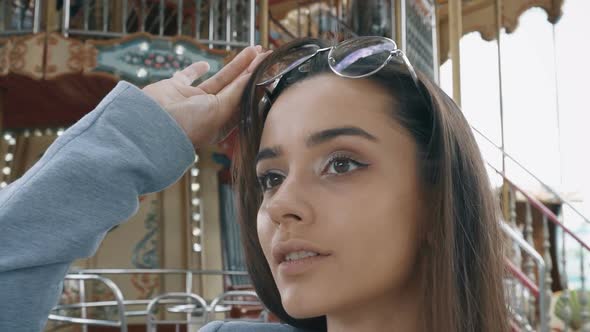 Elegant Woman in Amusement Park, Taking Sunglasses Off, Weekend Recreation