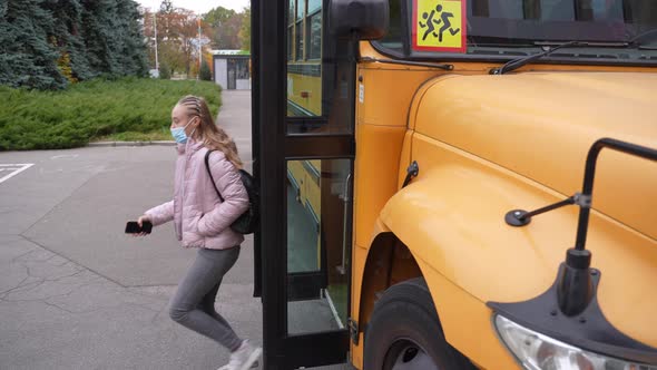 Multiracial Teens in Face Masks Leaving School Bus