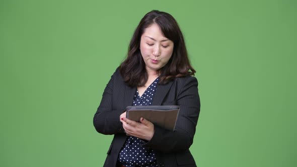 Mature Beautiful Asian Businesswoman Using Digital Tablet