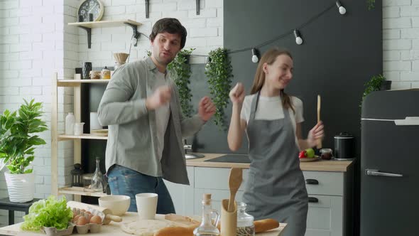 Happy Family Couple Dancing in Kitchen